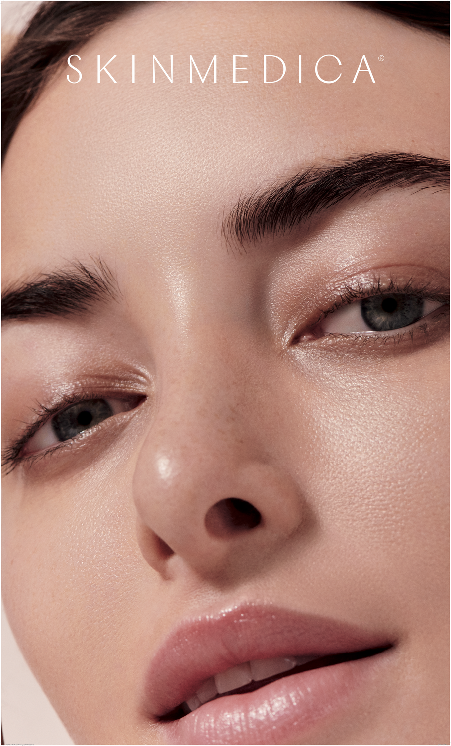 Smiling woman with freckles and curly hair.