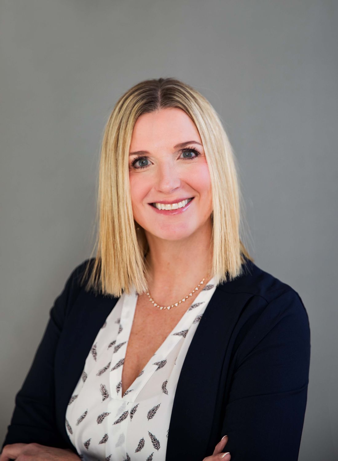 Woman in activewear with long, flowing hair.