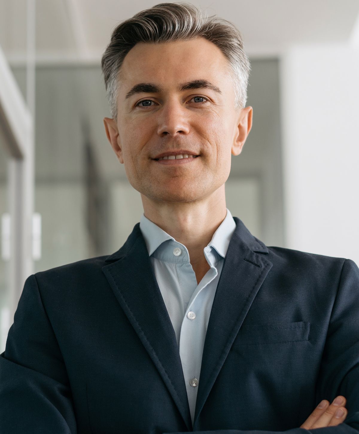 Smiling woman with freckles and curly hair.