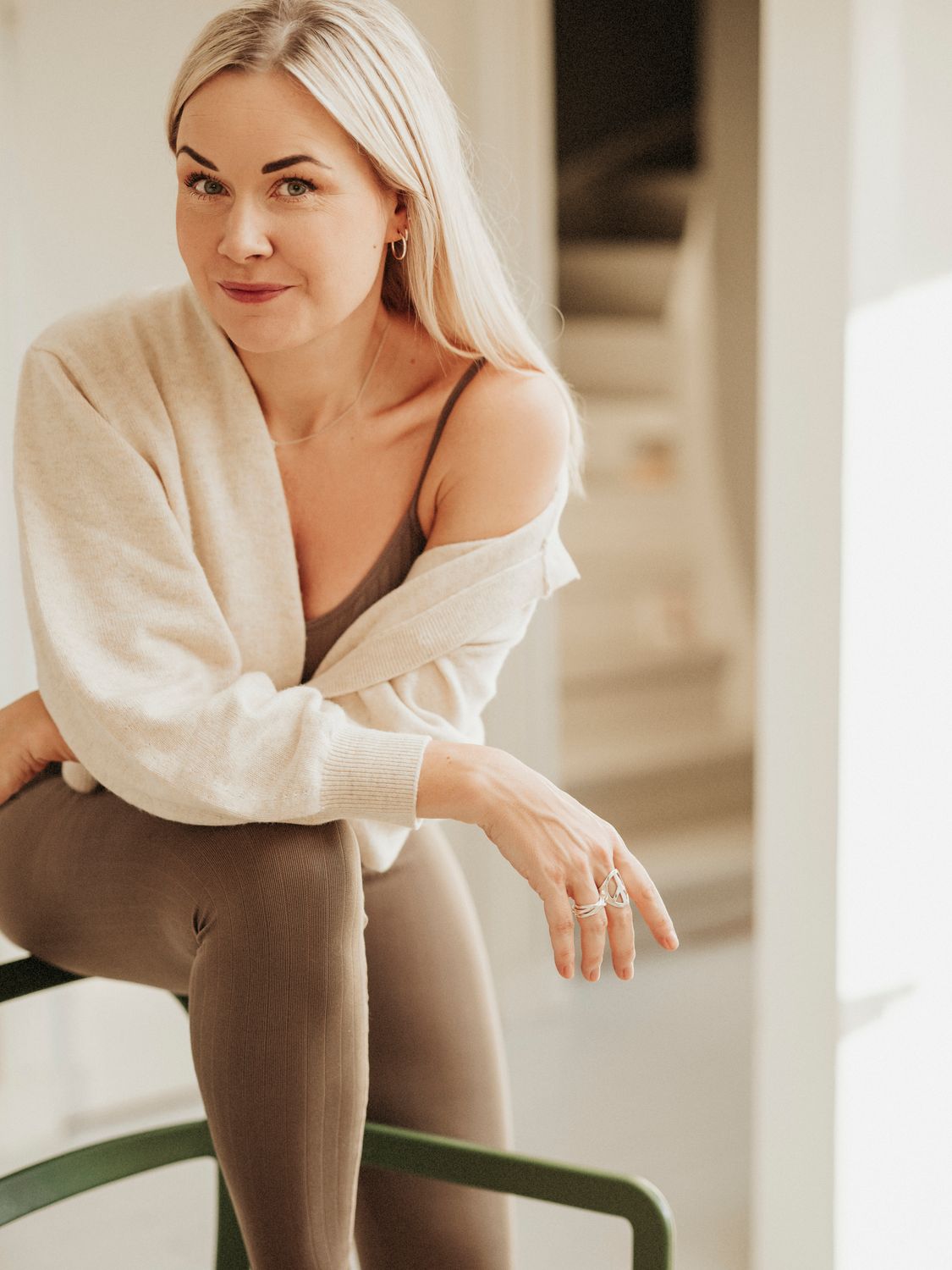Woman in activewear with long, flowing hair.