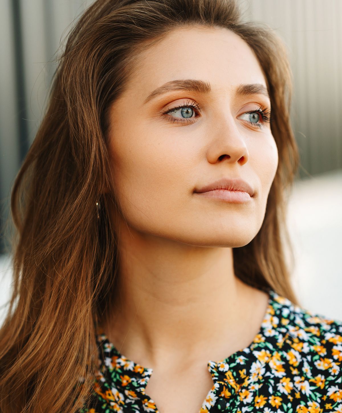 Smiling woman with freckles and curly hair.