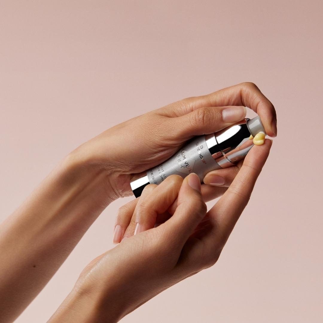 Smiling woman with blonde hair against gray background.