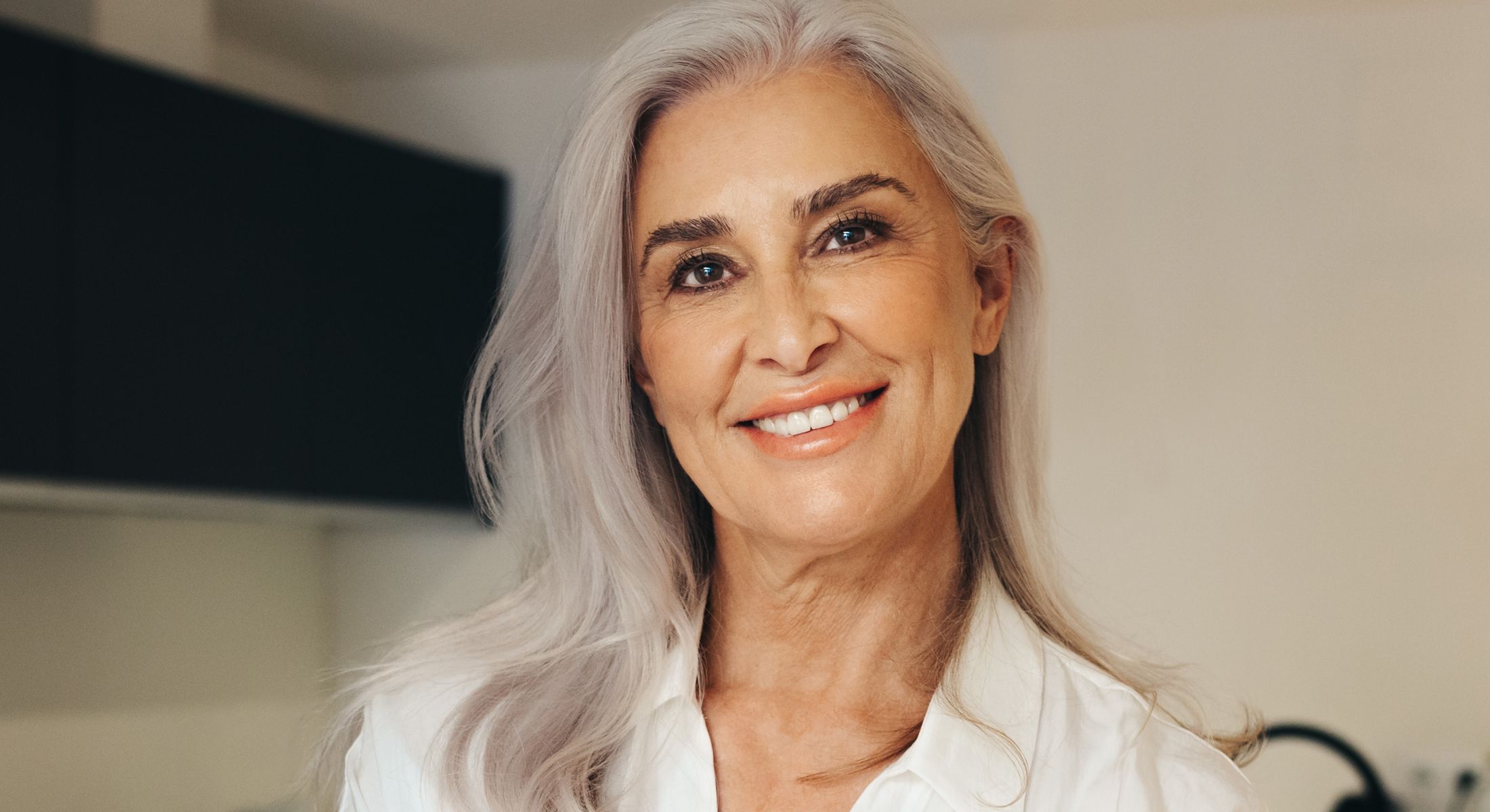Woman with curly hair in soft sunlight.