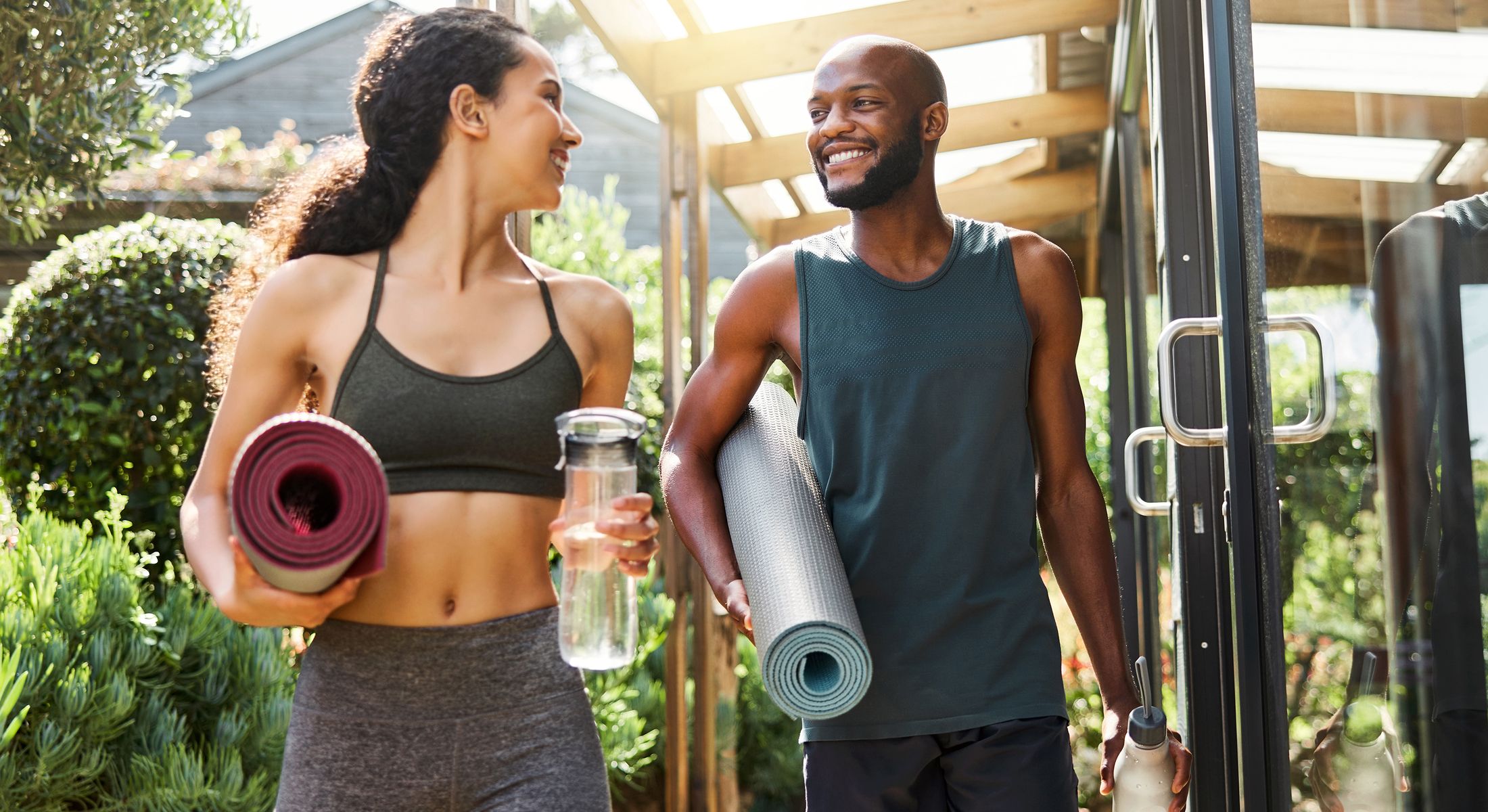 Woman joyfully splashing in water at sunset.