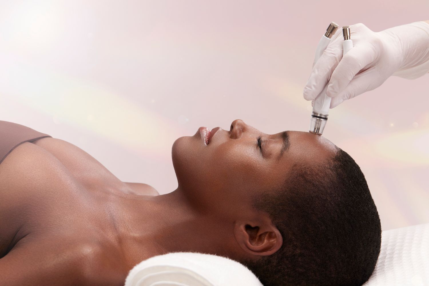 Smiling woman with curly hair and freckles.